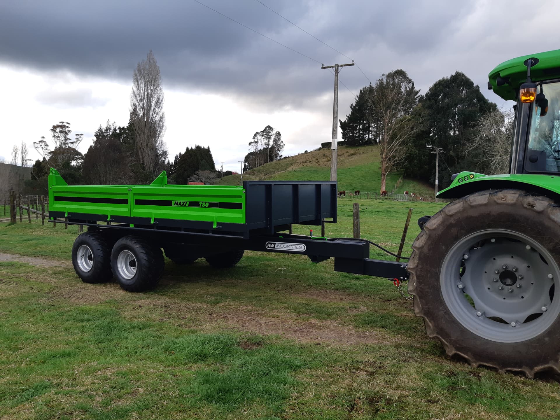 Green Maxi T80 tip trailer colour-matched to a Deutz tractor on a hill-country farm